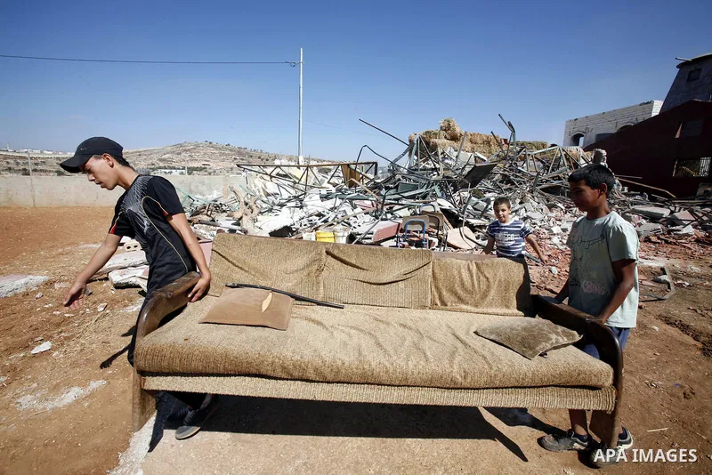 Palestinians inspect the damaged house that were built without a permit after it was demolished by an Israeli bulldozer, in the neighbourhood of Beit Hanina, in east Jerusalem, on Oct. 14, 2012. Israel regularly demolish...