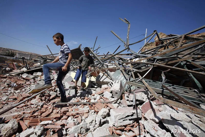 Palestinians inspect the damaged house that were built without a permit after it was demolished by an Israeli bulldozer, in the neighbourhood of Beit Hanina, in east Jerusalem, on Oct. 14, 2012. Israel regularly demolish...