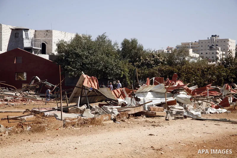 Palestinians inspect the damaged house that were built without a permit after it was demolished by an Israeli bulldozer, in the neighbourhood of Beit Hanina, in east Jerusalem, on Oct. 14, 2012. Israel regularly demolish...