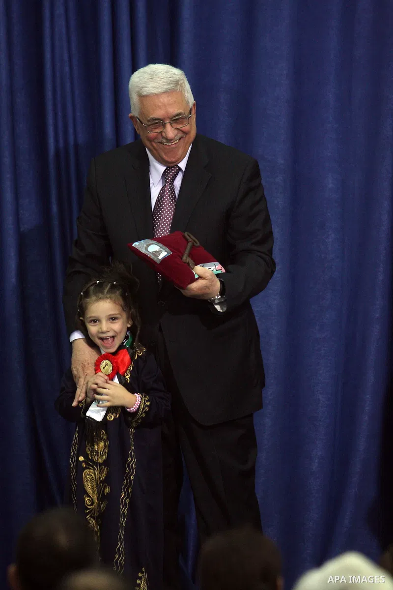 Palestinian leader Mahmoud Abbas holds a key to Jerusalem after is was given to him by families living in the holy city on October 13, 2012, in the West Bank city of Ramallah. Photo by Issam Rimawi