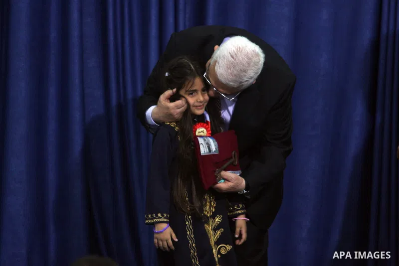 Palestinian leader Mahmoud Abbas holds a key to Jerusalem after is was given to him by families living in the holy city on October 13, 2012, in the West Bank city of Ramallah. Photo by Issam Rimawi