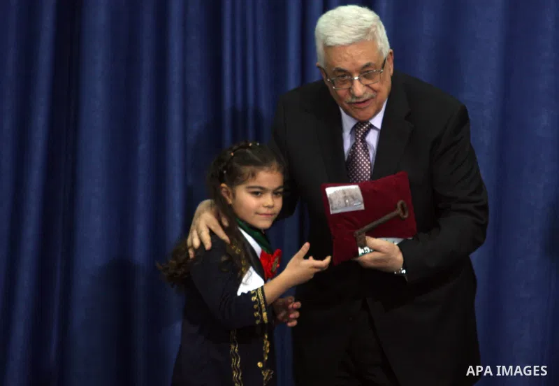 Palestinian leader Mahmoud Abbas holds a key to Jerusalem after is was given to him by families living in the holy city on October 13, 2012, in the West Bank city of Ramallah. Photo by Issam Rimawi
