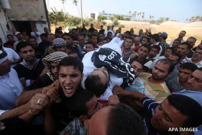 Mourners carry the bodies of of Mohammed Abu Ftair, 22, and Ezzedine Abu Nasira, 23, during funeral in Deir al-Balah in the central Gaza Strip October 15, 2012. An Israeli air strike in the central Gaza Strip on Sunday k...