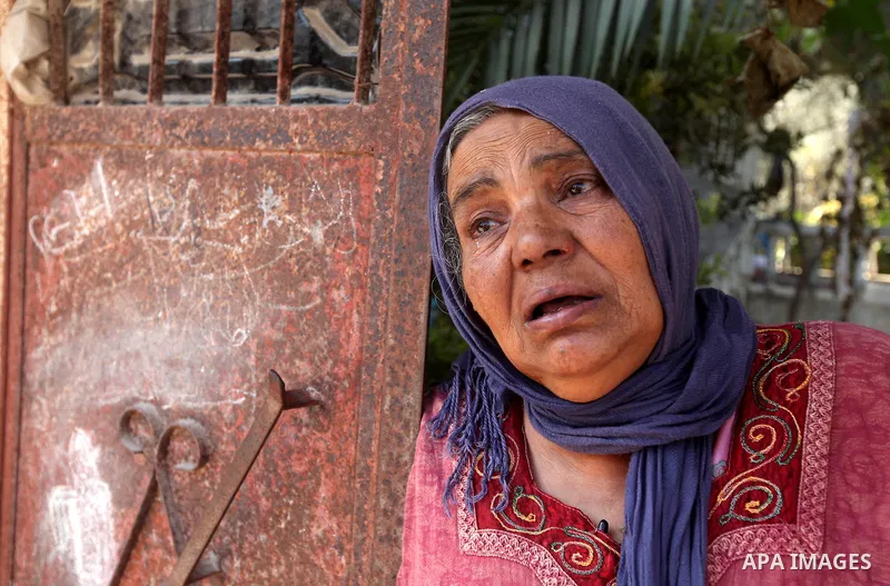 A Palestinian woman grieves during the funerals of Ahmad Fatayer, 22, and Ezzedine Abu Nasira, 23, in Deir al-Balah, in the central Gaza Strip, on October 15, 2012. Fatayer is one of two men killed the day before in an I...
