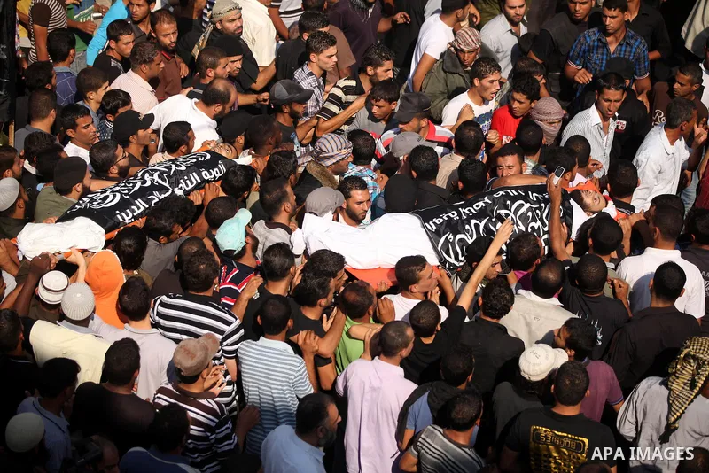 Mourners carry the bodies of of Mohammed Abu Ftair, 22, and Ezzedine Abu Nasira, 23, during funeral in Deir al-Balah in the central Gaza Strip October 15, 2012. An Israeli air strike in the central Gaza Strip on Sunday k...