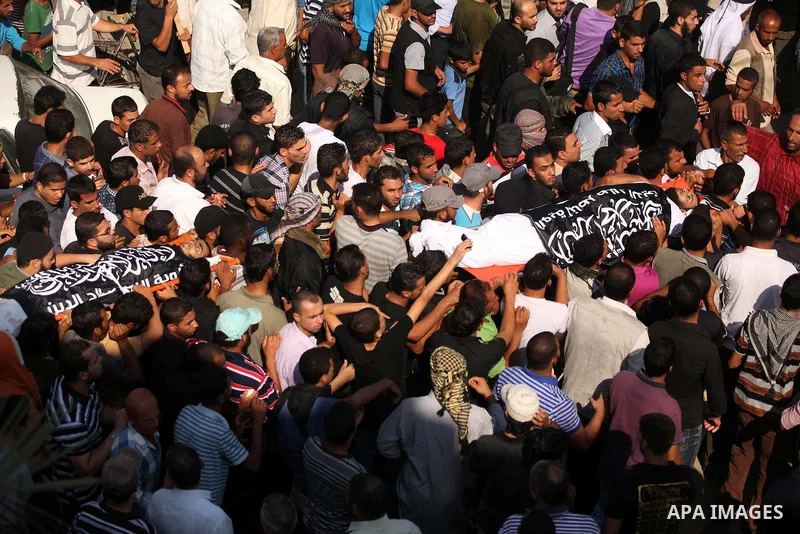 Mourners carry the bodies of of Mohammed Abu Ftair, 22, and Ezzedine Abu Nasira, 23, during funeral in Deir al-Balah in the central Gaza Strip October 15, 2012. An Israeli air strike in the central Gaza Strip on Sunday k...