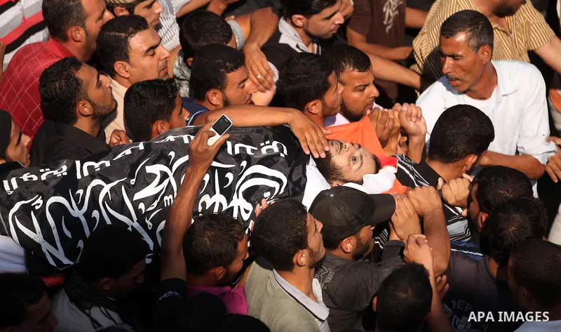 Mourners carry the body of a Palestinian militant, Mohammed Abu Ftair, during his funeral in Deir al-Balah in the central Gaza Strip October 15, 2012. An Israeli air strike in the central Gaza Strip on Sunday killed two...