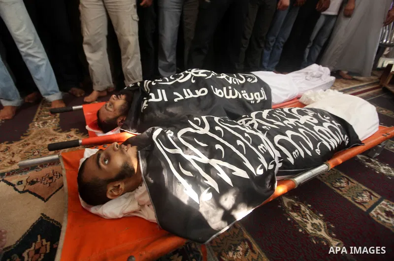 Mourners carry the bodies of of Mohammed Abu Ftair, 22, and Ezzedine Abu Nasira, 23, during funeral in Deir al-Balah in the central Gaza Strip October 15, 2012. An Israeli air strike in the central Gaza Strip on Sunday k...