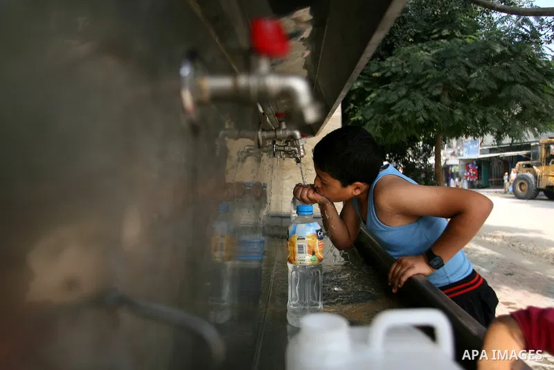Palestinian children fill plastic bottles with drinking water in Rafah camp southern Gaza Strip, on Oct. 16, 2012. The residents of the Gaza strip suffer from lack of potable water, Israel continues to tighten its blocka...