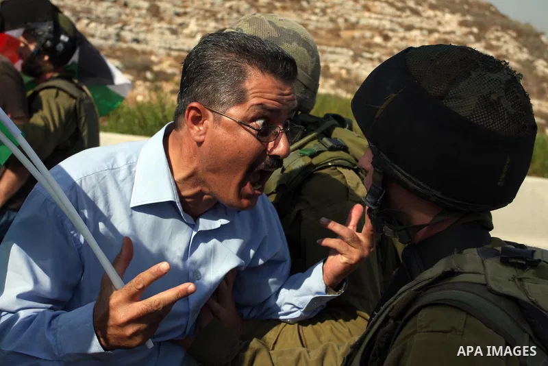 An Israeli border police officer,and an activist argue during a protest on highway 443 near the West Bank village of Beit Ur against what they say are attacks by Jewish settlers on Palestinians and their property, Octobe...
