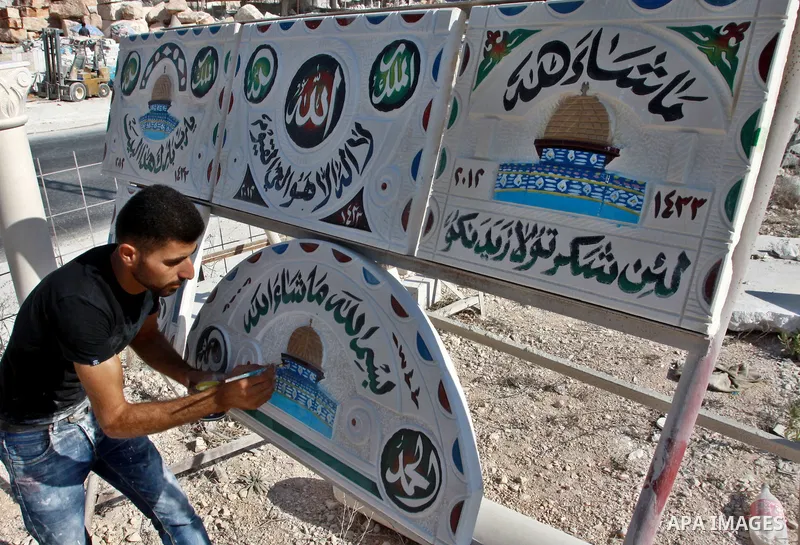 A Palestinian worker colors an encaustic of the Dome of the Rock mosque on a marble stone, in the West Bank city of Nablus on Oct. 17, 2012. Photo by Nedal Eshtayah