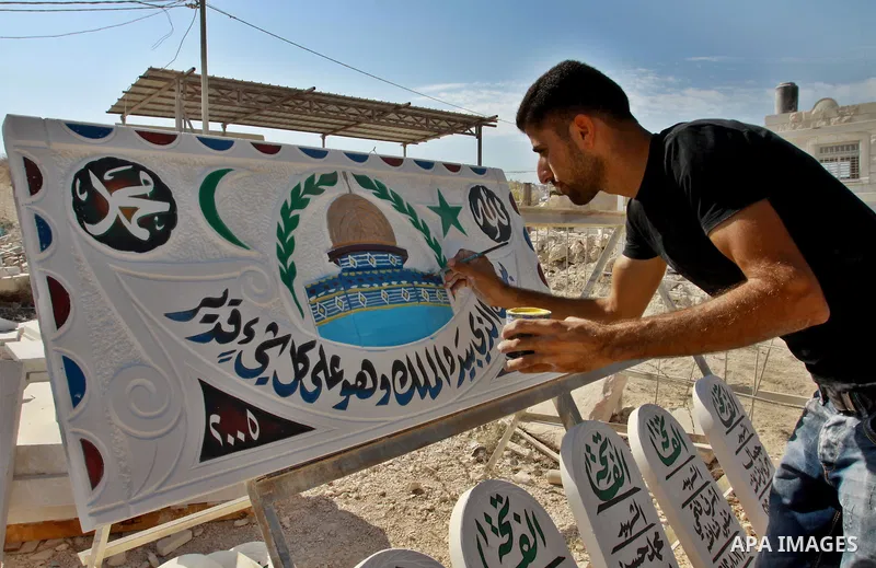 A Palestinian worker colors an encaustic of the Dome of the Rock mosque on a marble stone, in the West Bank city of Nablus on Oct. 17, 2012. Photo by Nedal Eshtayah