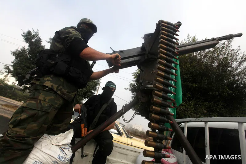 Palestinian Hamas militants take part in a march in the streets of Gaza City to mark the first anniversary of a deal which saw the exchange of 1,027 Palestinian prisoners for captured Israeli soldier Gilad Shalit, on Oct...