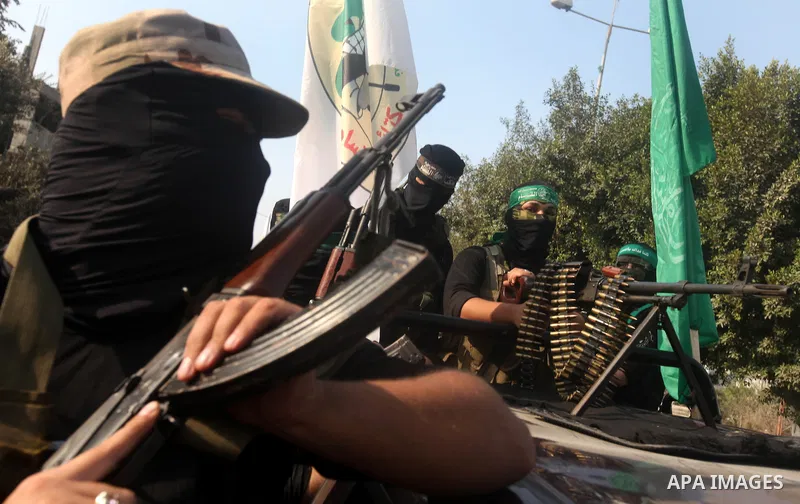 Palestinian Hamas militants take part in a march in the streets of Gaza City to mark the first anniversary of a deal which saw the exchange of 1,027 Palestinian prisoners for captured Israeli soldier Gilad Shalit, on Oct...