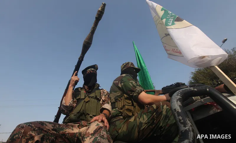 Palestinian Hamas militants take part in a march in the streets of Gaza City to mark the first anniversary of a deal which saw the exchange of 1,027 Palestinian prisoners for captured Israeli soldier Gilad Shalit, on Oct...