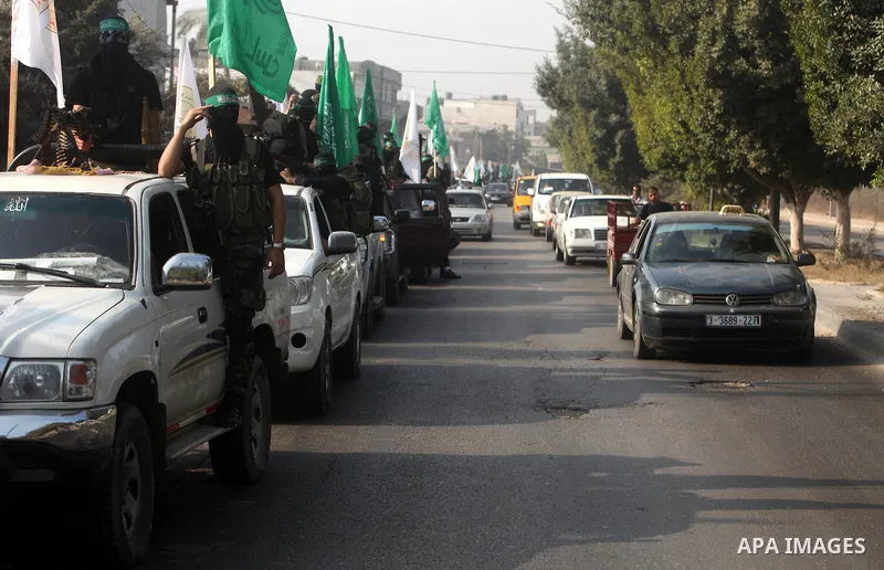 Palestinian Hamas militants take part in a march in the streets of Gaza City to mark the first anniversary of a deal which saw the exchange of 1,027 Palestinian prisoners for captured Israeli soldier Gilad Shalit, on Oct...