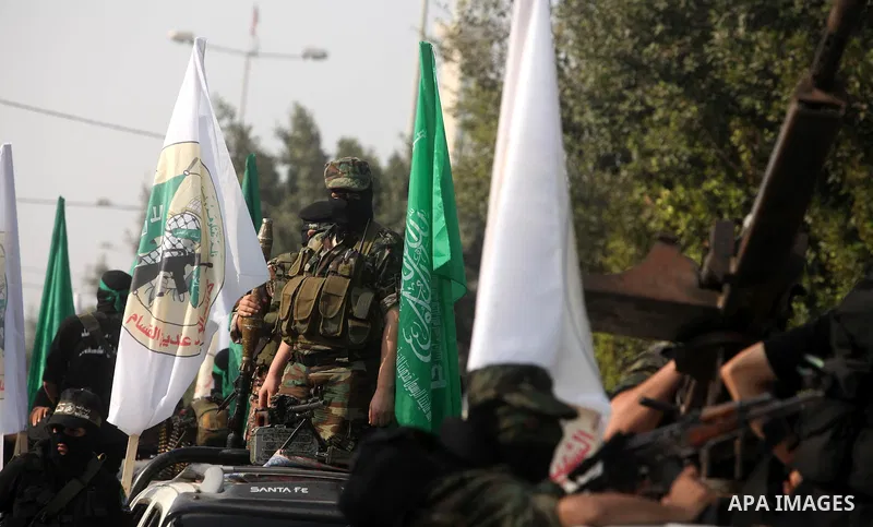 Palestinian Hamas militants take part in a march in the streets of Gaza City to mark the first anniversary of a deal which saw the exchange of 1,027 Palestinian prisoners for captured Israeli soldier Gilad Shalit, on Oct...