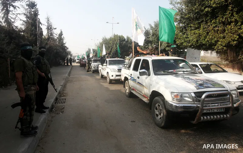 Palestinian Hamas militants take part in a march in the streets of Gaza City to mark the first anniversary of a deal which saw the exchange of 1,027 Palestinian prisoners for captured Israeli soldier Gilad Shalit, on Oct...
