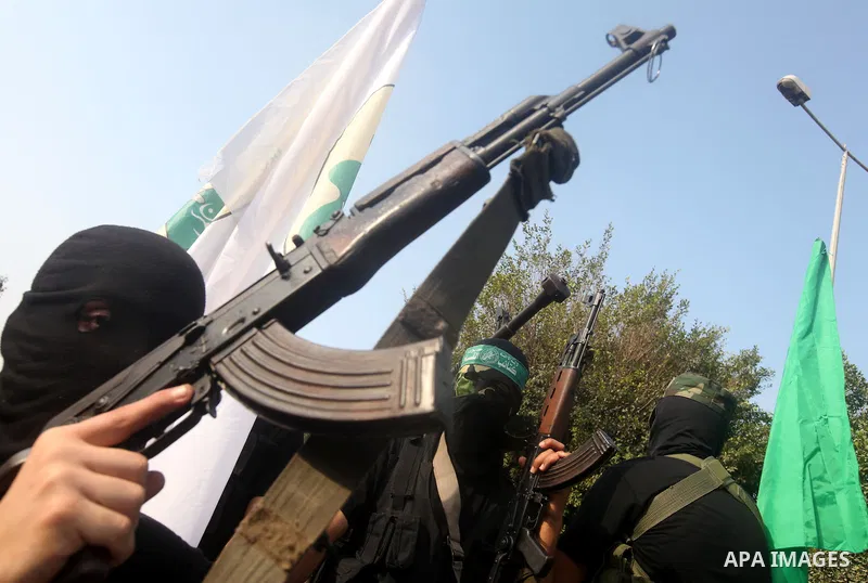 Palestinian Hamas militants take part in a march in the streets of Gaza City to mark the first anniversary of a deal which saw the exchange of 1,027 Palestinian prisoners for captured Israeli soldier Gilad Shalit, on Oct...