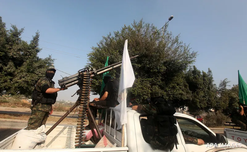 Palestinian Hamas militants take part in a march in the streets of Gaza City to mark the first anniversary of a deal which saw the exchange of 1,027 Palestinian prisoners for captured Israeli soldier Gilad Shalit, on Oct...