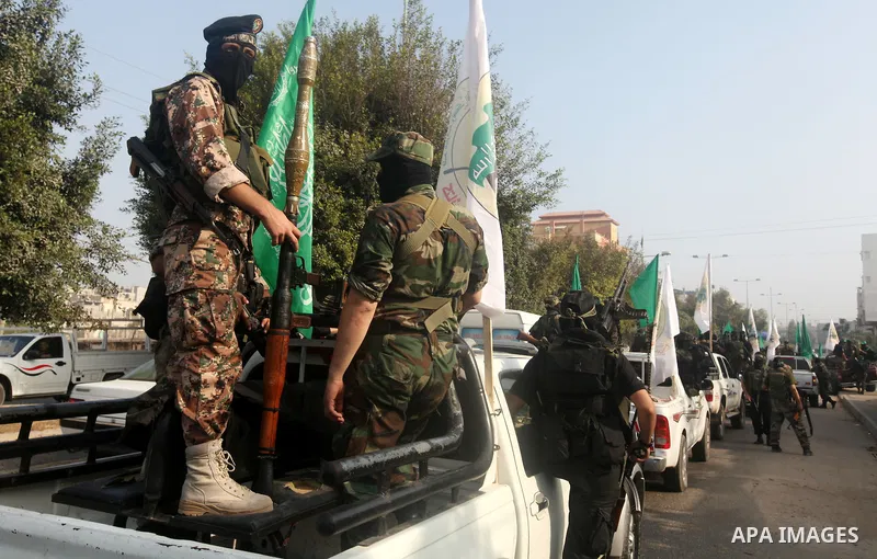 Palestinian Hamas militants take part in a march in the streets of Gaza City to mark the first anniversary of a deal which saw the exchange of 1,027 Palestinian prisoners for captured Israeli soldier Gilad Shalit, on Oct...