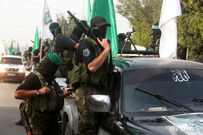 Palestinian Hamas militants take part in a march in the streets of Gaza City to mark the first anniversary of a deal which saw the exchange of 1,027 Palestinian prisoners for captured Israeli soldier Gilad Shalit, on Oct...