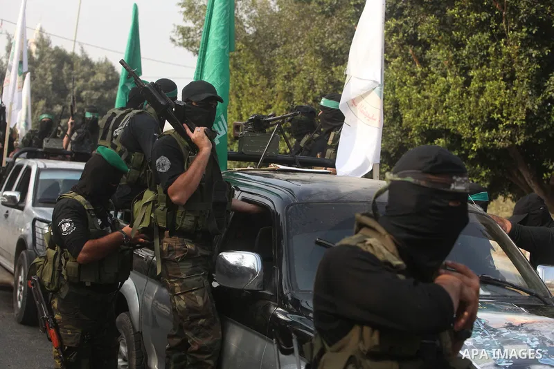 Palestinian Hamas militants take part in a march in the streets of Gaza City to mark the first anniversary of a deal which saw the exchange of 1,027 Palestinian prisoners for captured Israeli soldier Gilad Shalit, on Oct...