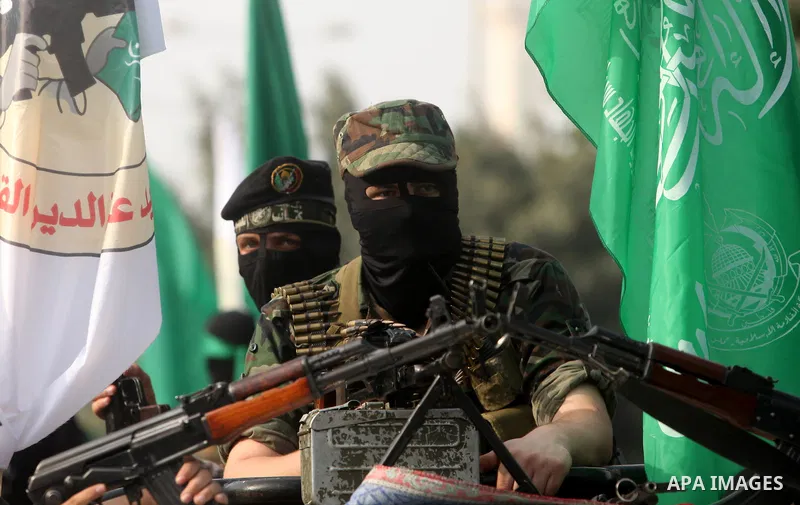 Palestinian Hamas militants take part in a march in the streets of Gaza City to mark the first anniversary of a deal which saw the exchange of 1,027 Palestinian prisoners for captured Israeli soldier Gilad Shalit, on Oct...