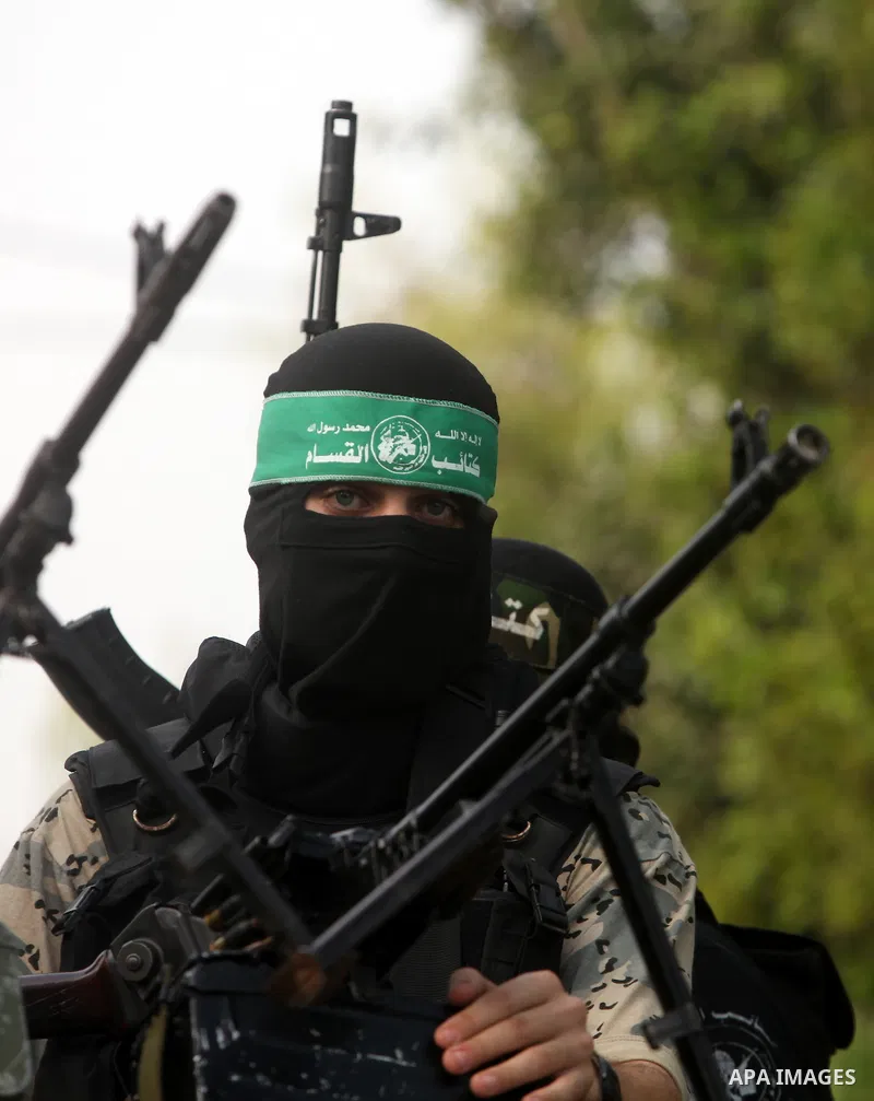 Palestinian Hamas militants take part in a march in the streets of Gaza City to mark the first anniversary of a deal which saw the exchange of 1,027 Palestinian prisoners for captured Israeli soldier Gilad Shalit, on Oct...