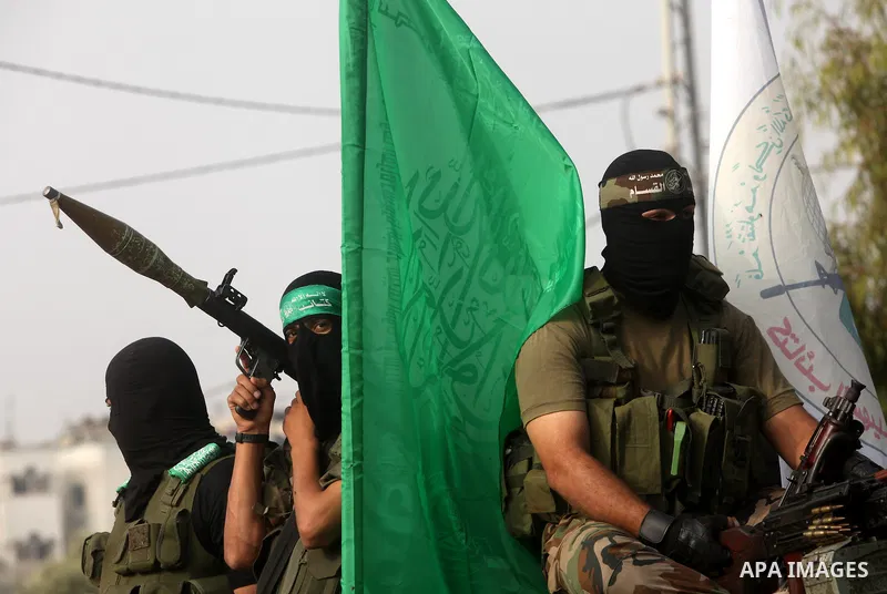 Palestinian Hamas militants take part in a march in the streets of Gaza City to mark the first anniversary of a deal which saw the exchange of 1,027 Palestinian prisoners for captured Israeli soldier Gilad Shalit, on Oct...