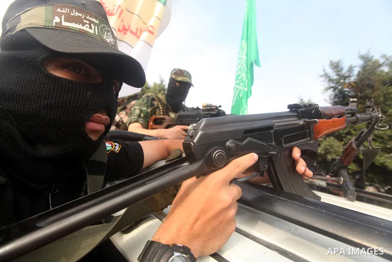 Palestinian Hamas militants take part in a march in the streets of Gaza City to mark the first anniversary of a deal which saw the exchange of 1,027 Palestinian prisoners for captured Israeli soldier Gilad Shalit, on Oct...