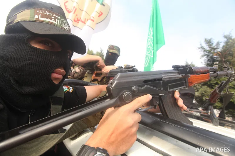 Palestinian Hamas militants take part in a march in the streets of Gaza City to mark the first anniversary of a deal which saw the exchange of 1,027 Palestinian prisoners for captured Israeli soldier Gilad Shalit, on Oct...