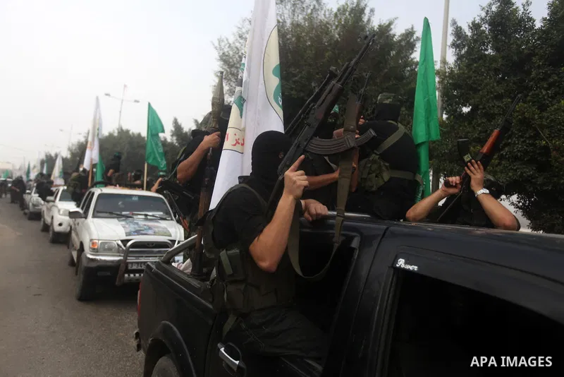 Palestinian Hamas militants take part in a march in the streets of Gaza City to mark the first anniversary of a deal which saw the exchange of 1,027 Palestinian prisoners for captured Israeli soldier Gilad Shalit, on Oct...