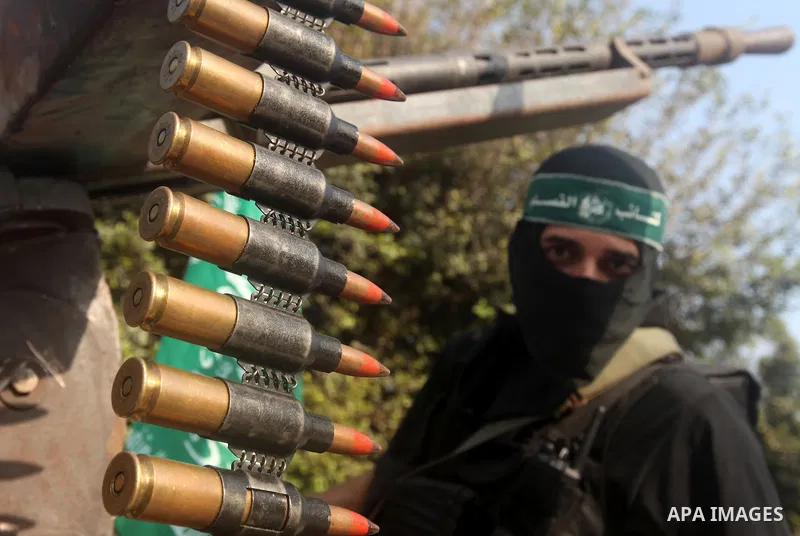 Palestinian Hamas militants take part in a march in the streets of Gaza City to mark the first anniversary of a deal which saw the exchange of 1,027 Palestinian prisoners for captured Israeli soldier Gilad Shalit, on Oct...