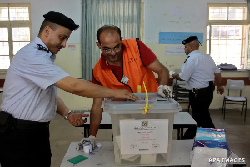 Members of the Palestinian security vote at a polling station during local elections in the West Bank city of Nablus, on October 18,2012. Members of Palestinian security forces cast an early vote ahead of local elections...