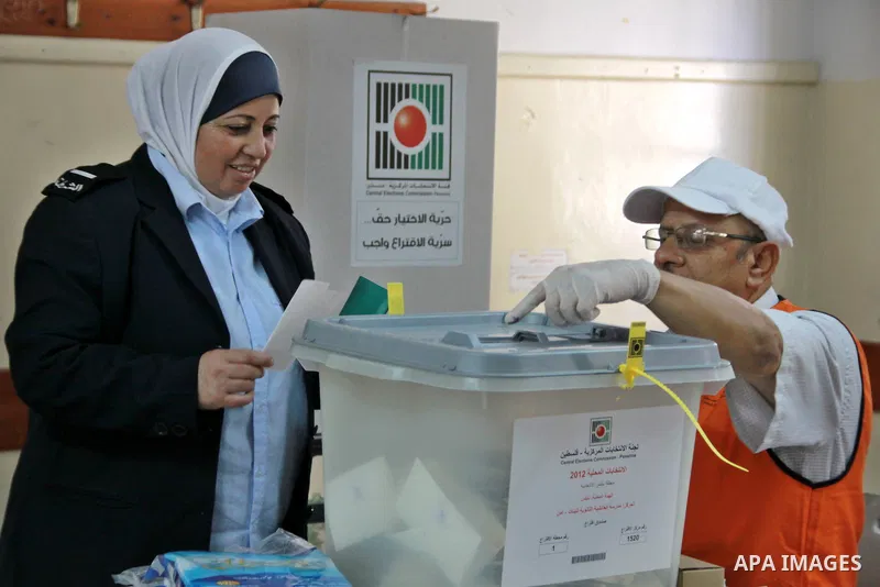 Members of the Palestinian security vote at a polling station during local elections in the West Bank city of Nablus, on October 18,2012. Members of Palestinian security forces cast an early vote ahead of local elections...