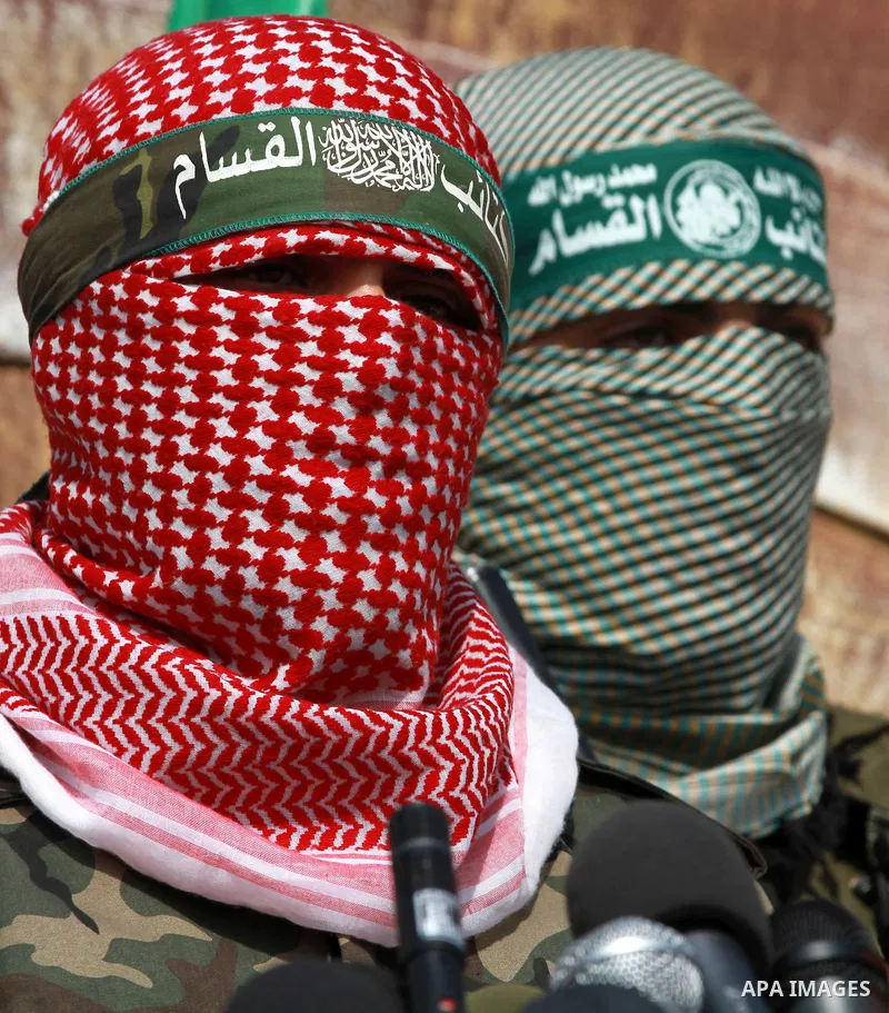 Abu Obaida (C), the spokesman for the Ezzedine Al-Qassam Brigades, the armed wing of Hamas, speaks during a news conference on October 18, 2012 at the Rafah border crossing with Egypt in the southern Gaza Strip to mark t...