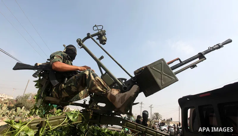 Palestinian Hamas militants take part in a rally on October 18, 2012 at the Rafah border crossing with Egypt in the southern Gaza Strip to mark the first anniversary of a deal which saw the exchange of 1,027 Palestinian...