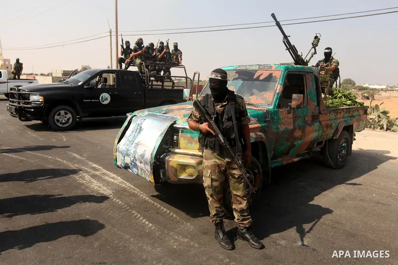 Palestinian Hamas militants take part in a rally on October 18, 2012 at the Rafah border crossing with Egypt in the southern Gaza Strip to mark the first anniversary of a deal which saw the exchange of 1,027 Palestinian...