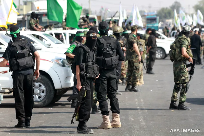 Palestinian Hamas militants take part in a rally on October 18, 2012 at the Rafah border crossing with Egypt in the southern Gaza Strip to mark the first anniversary of a deal which saw the exchange of 1,027 Palestinian...