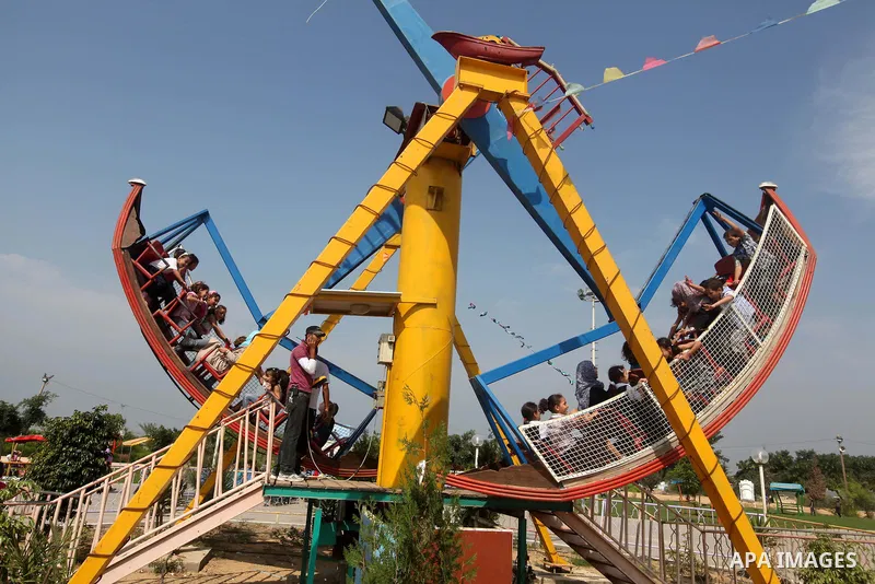 Palestinian children ride a Ferris Wheel at the Al-Bashir amusement park on the outskirts of Gaza City on Oct. 18, 2012. Photo by Majdi Fathi