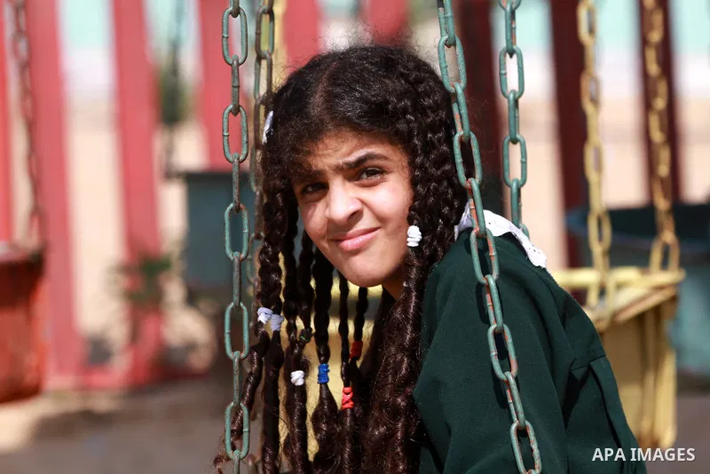 A Palestinian student rides a Ferris Wheel at the Al-Bashir amusement park on the outskirts of Gaza City on Oct. 18, 2012. Photo by Majdi Fathi