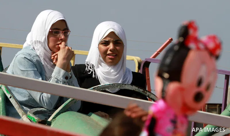 Palestinian students ride a Ferris Wheel at the Al-Bashir amusement park on the outskirts of Gaza City on Oct. 18, 2012. Photo by Majdi Fathi