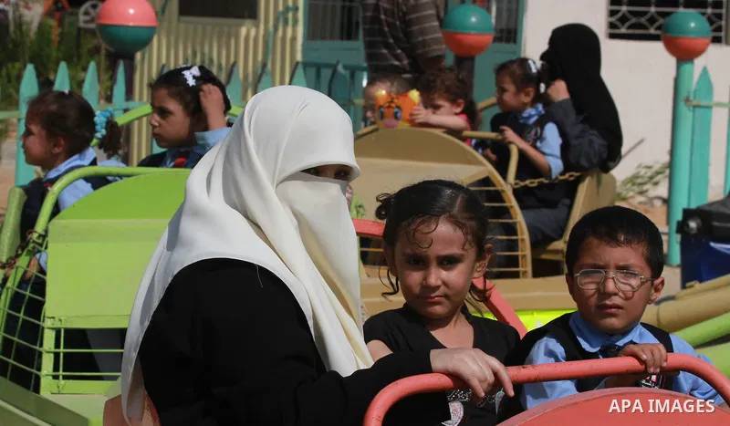 Palestinian children ride a Ferris Wheel at the Al-Bashir amusement park on the outskirts of Gaza City on Oct. 18, 2012. Photo by Majdi Fathi