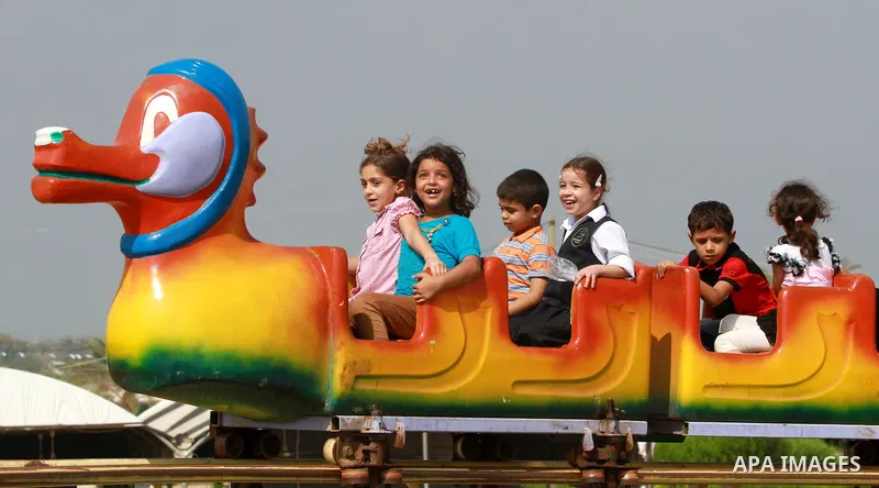 Palestinian children ride a Ferris Wheel at the Al-Bashir amusement park on the outskirts of Gaza City on Oct. 18, 2012. Photo by Majdi Fathi