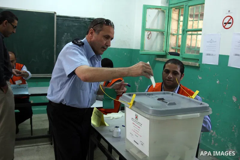 A Palestinian police officer casts his vote at a polling station in the West bank town of Ramallah, 18 October 2012. The polling stations will be open from seven AM to seven PM for about 13,000 members of the security fo...