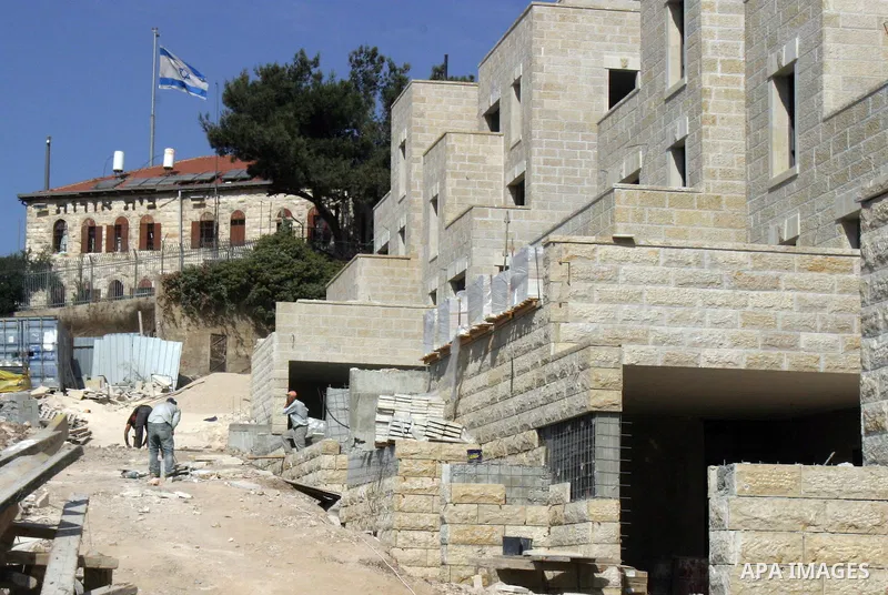 Labourers work in the jewish settlement of Harmoun Hanatsave near the Arab neighbourhood of Ras al-Amud in Jerusalem on Oct. 18,2012. Israeli government continue building Harmoun Hanatsave on the Arab villages of Jabal a...