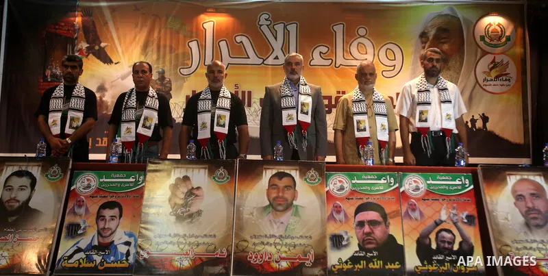 Palestinian Prime Minister in Gaza Ismail Haniyeh (C) attends a ceremony to mark the first anniversary of a deal which saw the exchange of 1,027 Palestinian prisoners for captured Israeli soldier Gilad Shalit, in Gaza ci...