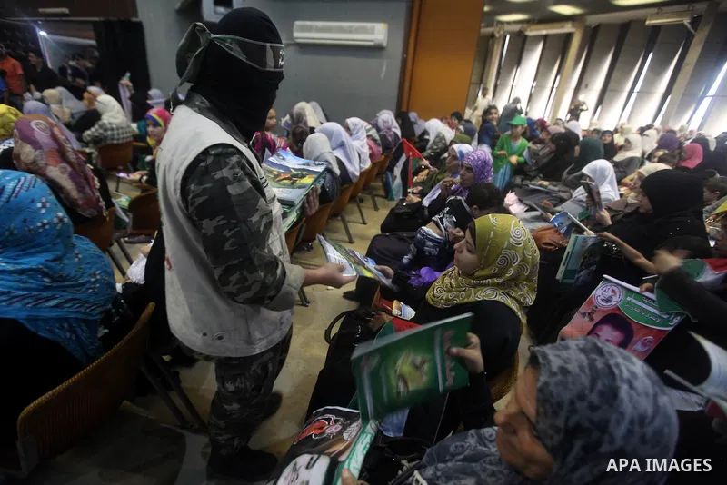 A Palestinian Hamas militant delivers magazines during a ceremony to mark the first anniversary of a deal which saw the exchange of 1,027 Palestinian prisoners for captured Israeli soldier Gilad Shalit, in Gaza city on 1...