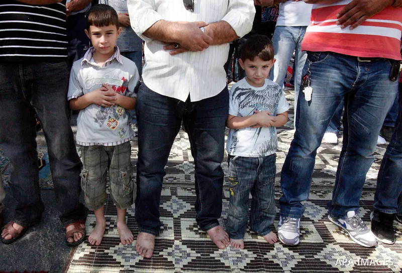 Palestinian Muslim worshippers attend Friday prayers outside a protest tent against the continuing 'Judaization of Jerusalem' by Jewish settlers, in the mostly Arab neighbourhood of Silwan in east Jerusalem on Oct. 19, 2...